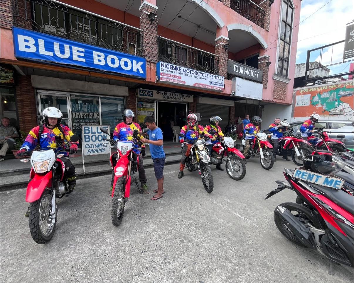 Group of customers with dirt bikes outside NiceBike